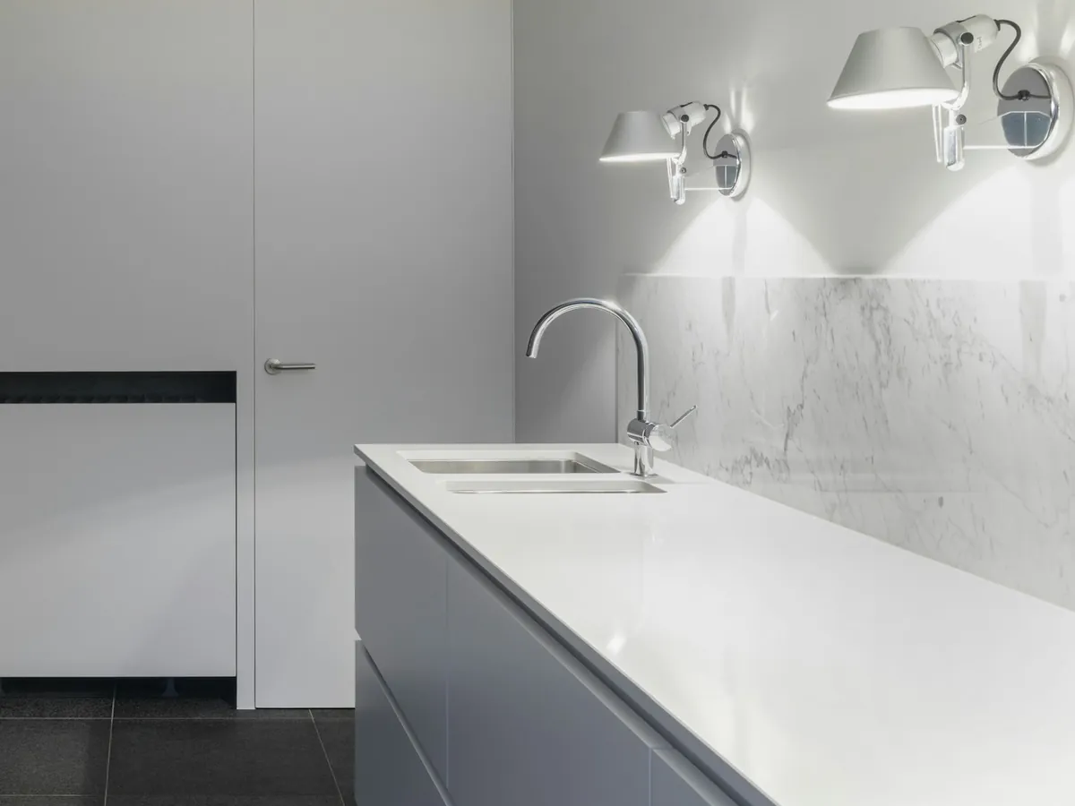 Minimal kitchen counter with a chrome faucet and double sink