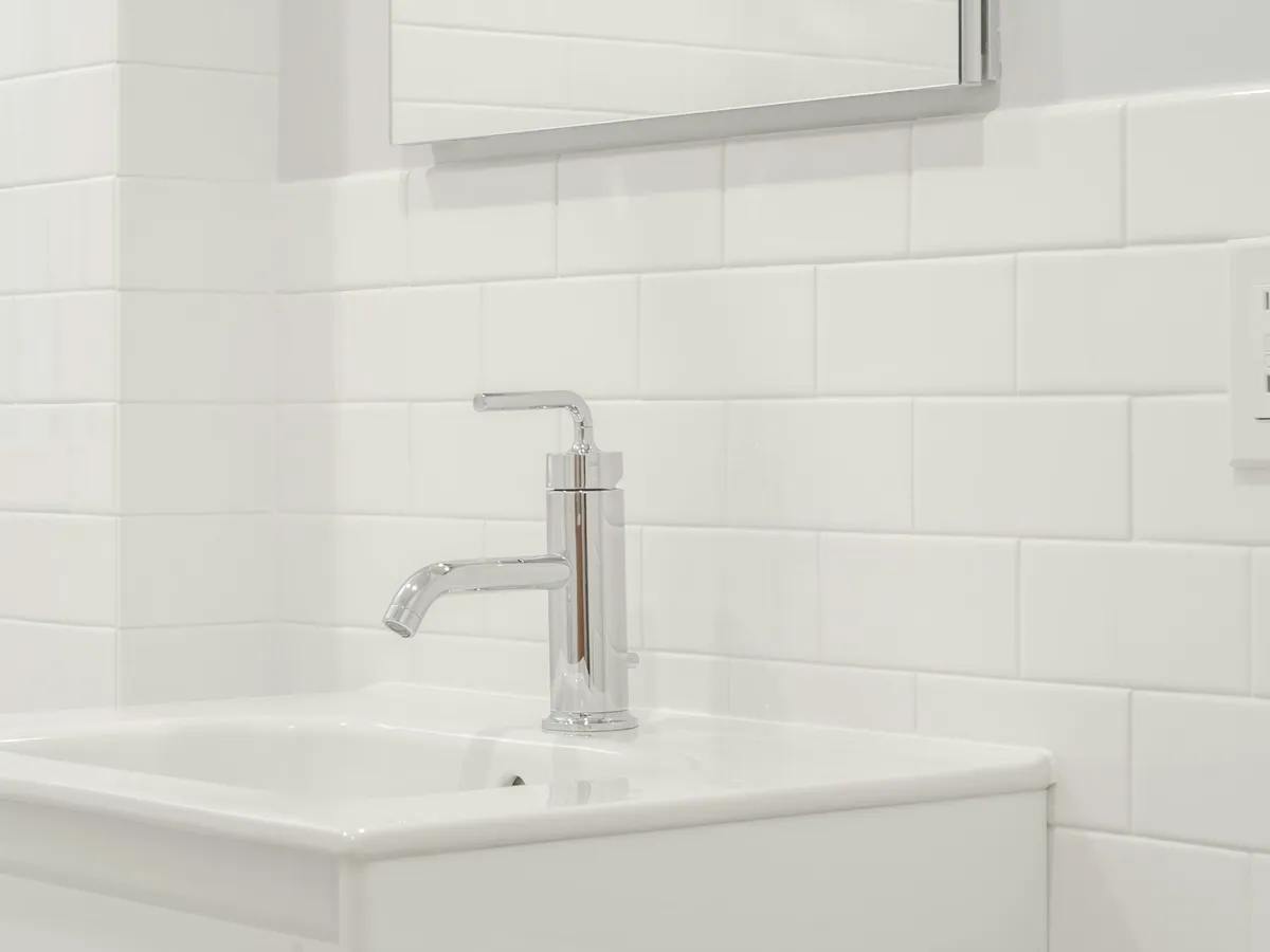 Chrome basin faucet on a white washbasin