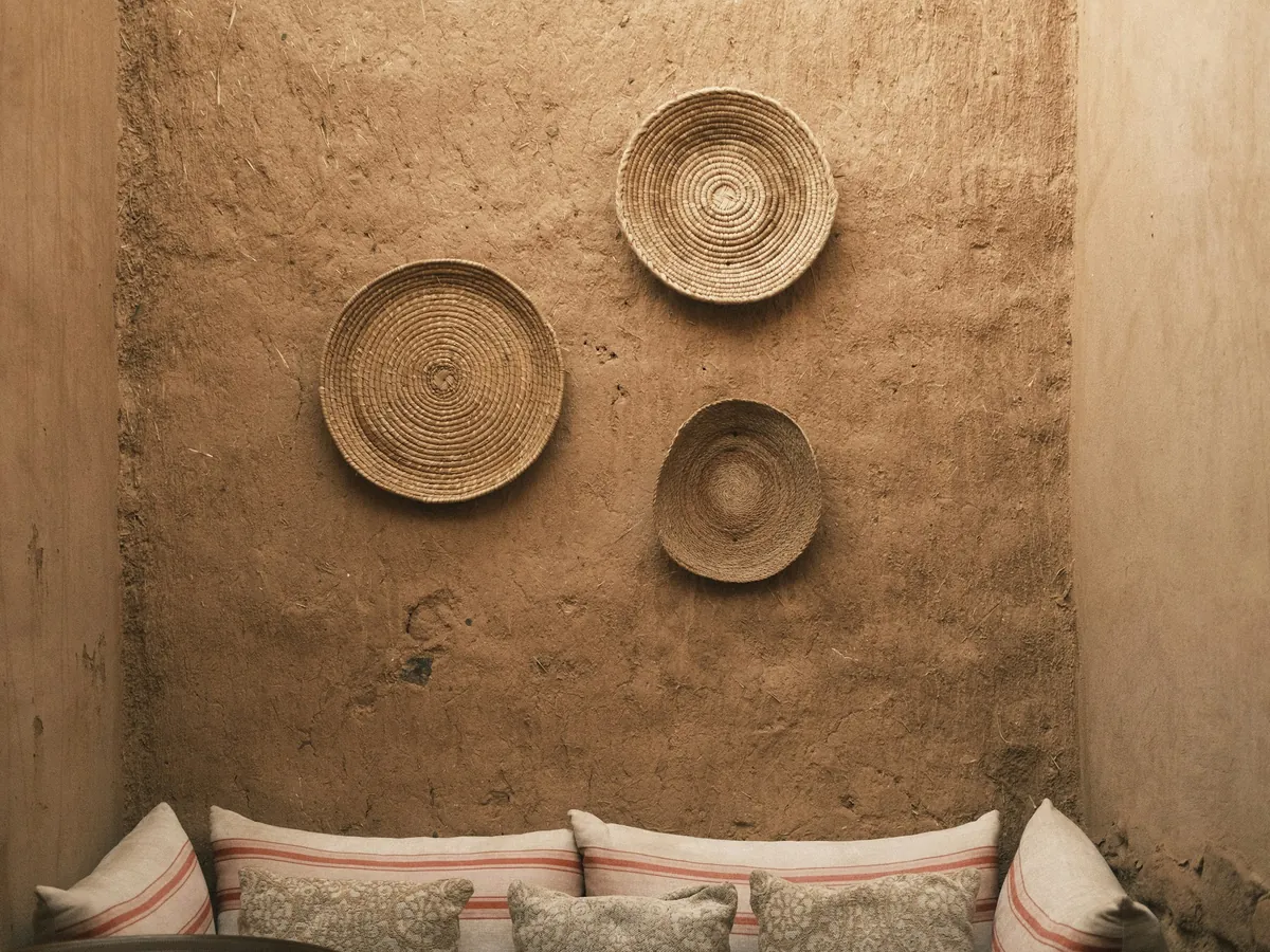 Woven wall baskets above cushions